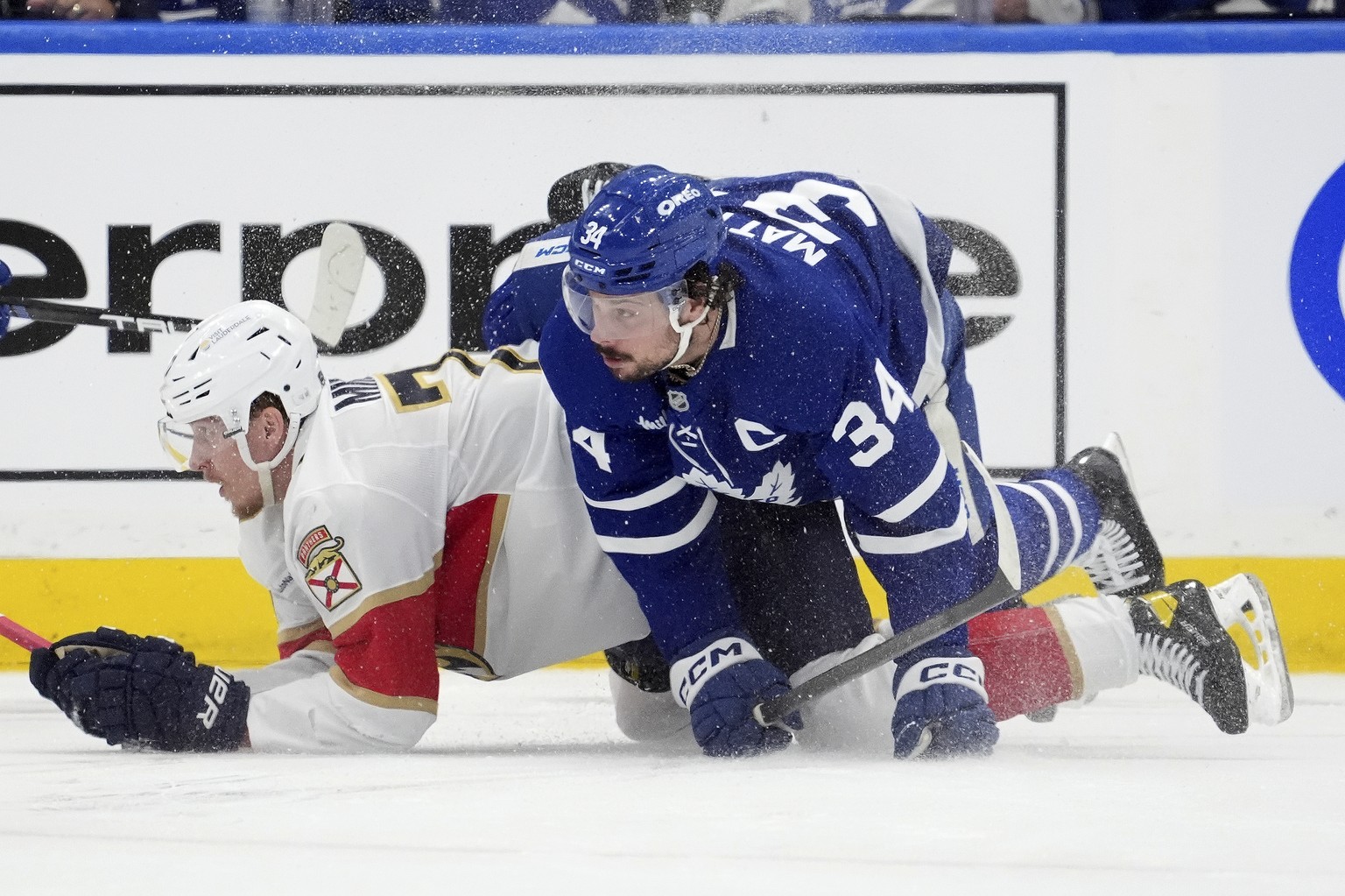 Toronto Maple Leafs center Auston Matthews (34) and Florida Panthers defenseman Niko Mikkola, left, look on after colliding during the first period of Game 7 of a second-round NHL hockey playoff serie ...