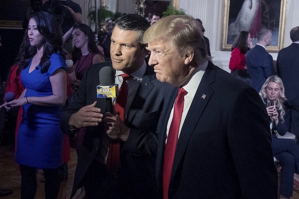 FILE - President Donald Trump, right, appears on &quot;Fox &amp; Friends&quot; with co-host Pete Hegseth in the East Room of the White House in Washington, April 6, 2017. (AP Photo/Andrew Harnik, File ...