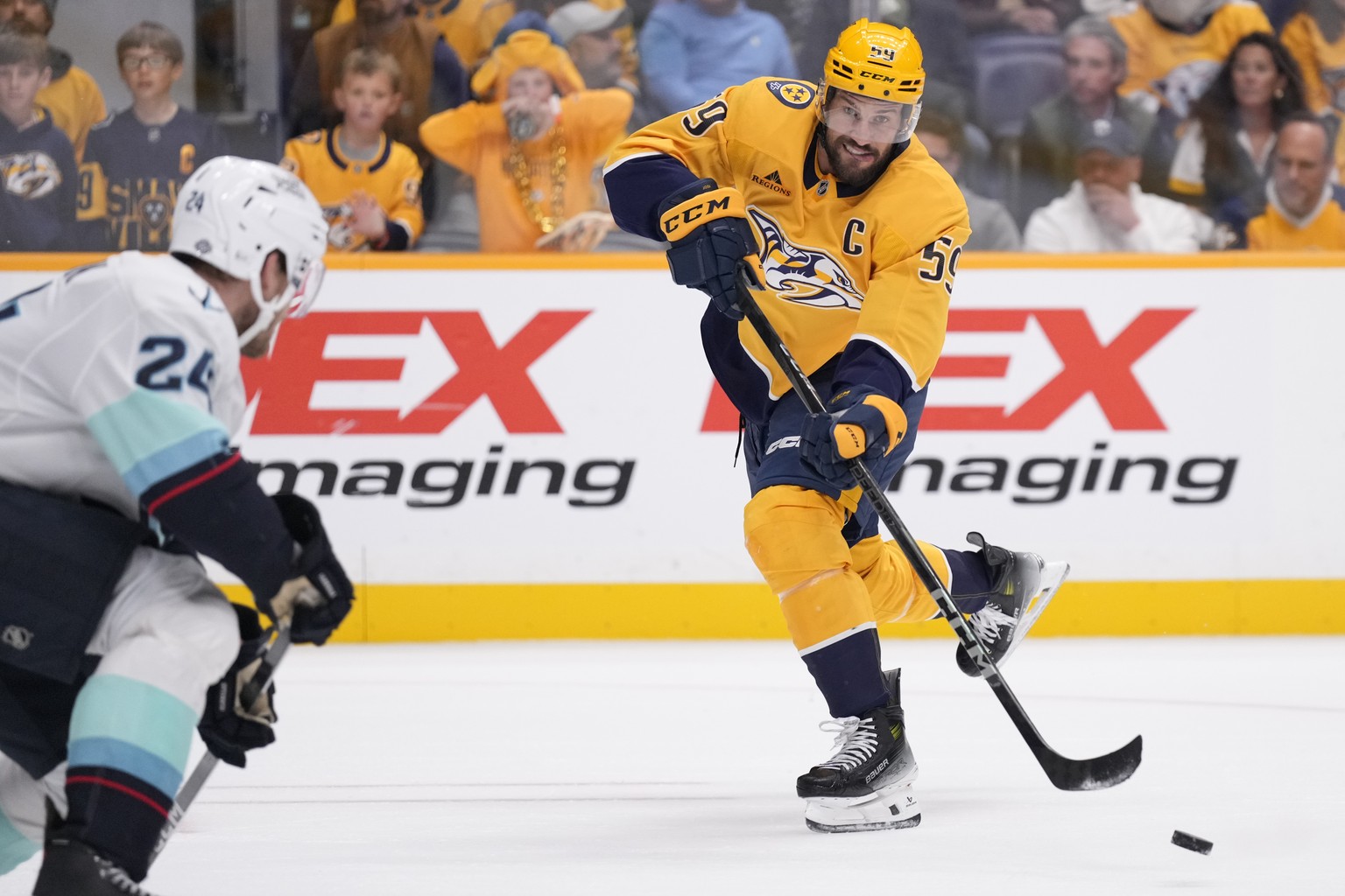 Nashville Predators defenseman Roman Josi (59) passes the puck past Seattle Kraken defenseman Jamie Oleksiak (24) during the second period of an NHL hockey game Tuesday, Oct. 15, 2024, in Nashville, T ...