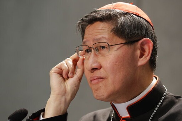 FILE - President of Caritas Internationalis Cardinal Luis Antonio Gokim Tagle makes a point during a press conference announcing the launch of a campaign on the plight of migrants to counteract mounti ...