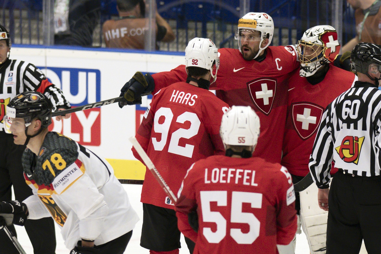 Switzerland&#039;s Gaetan Haas, Roman Josi and Goalkeeper Leonardo Genoni, from left, celebrate their victory during the Ice Hockey World Championship quarter final match between Switzerland and Germa ...