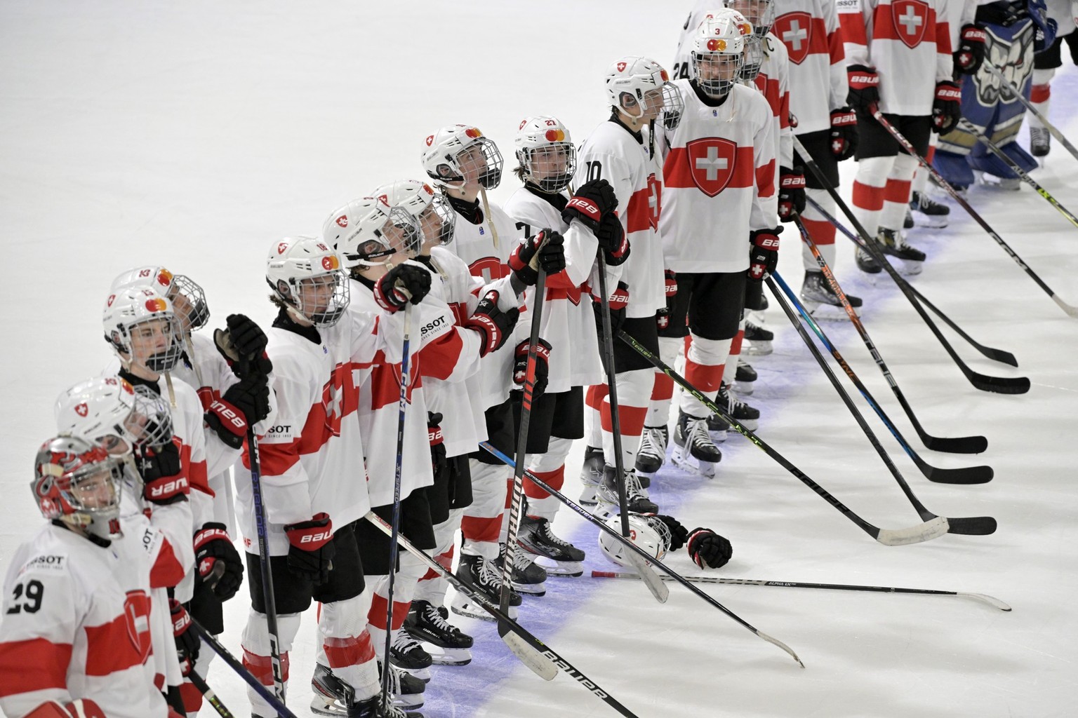 Switzerland&#039;s disappointed players after being eliminated in the quarterfinal match of the 2023 IIHF Ice Hockey U18 World Championship between Canada and Switzerland at the St. Jakob-Arena in Bas ...