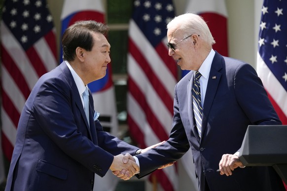 FILE - President Joe Biden, right, and South Korea&#039;s President Yoon Suk Yeol shake hands during a news conference in the Rose Garden of the White House, April 26, 2023, in Washington. (AP Photo/A ...